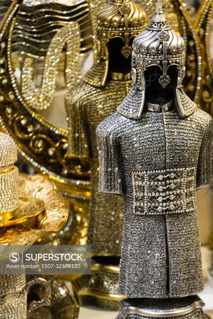 Medieval steel and gold colored armours on display