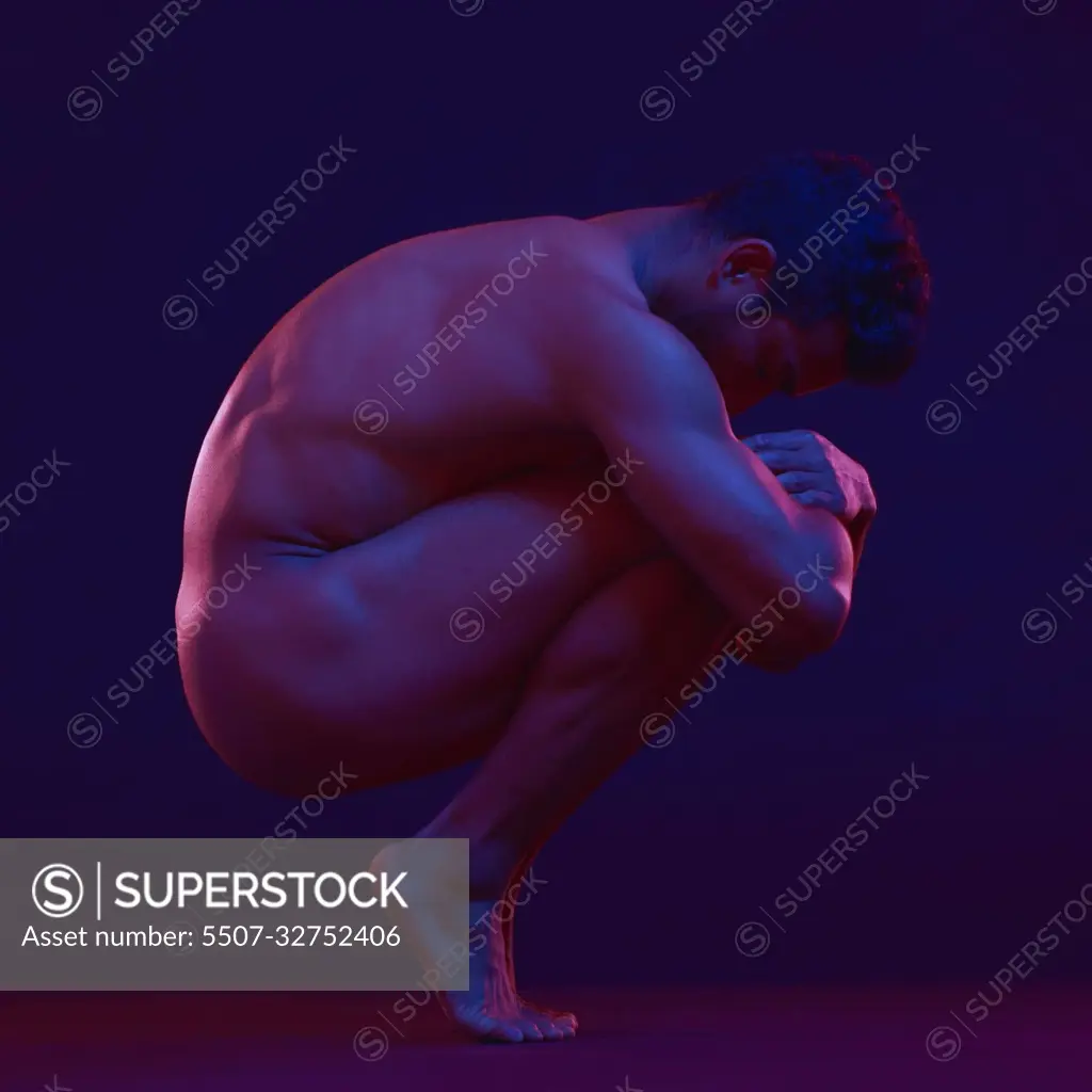 Nude, art and fetal with a model asian man in studio on a dark background  for artistic body positivity. Skin, natural and freedom with a handsome  young male posing naked on a