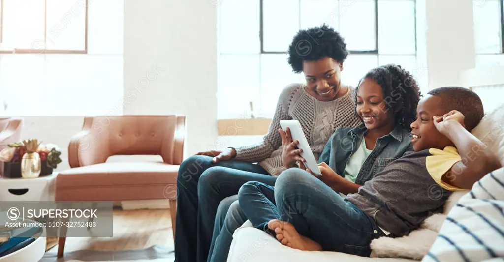 Family with tablet, streaming and relax at family home together, spending quality time together with technology. Black people, mother and children on sofa with device, internet wifi and social media