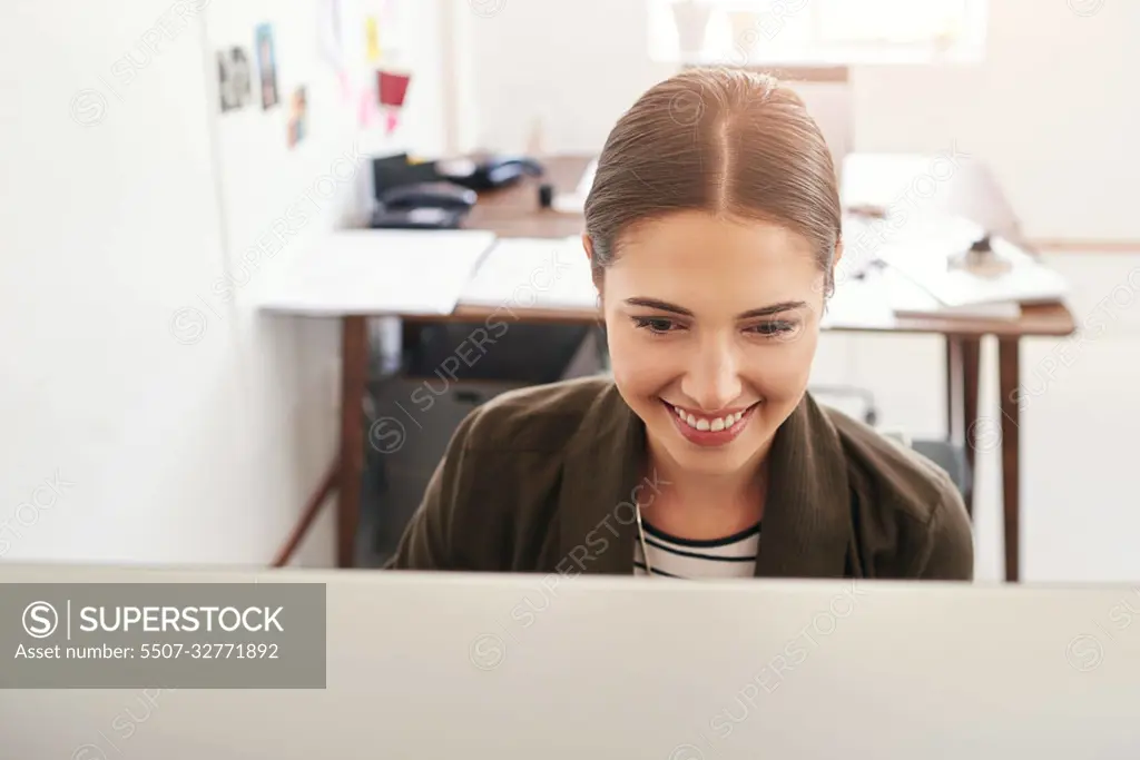 Working hard to achieve success. a young businesswoman working in her office.