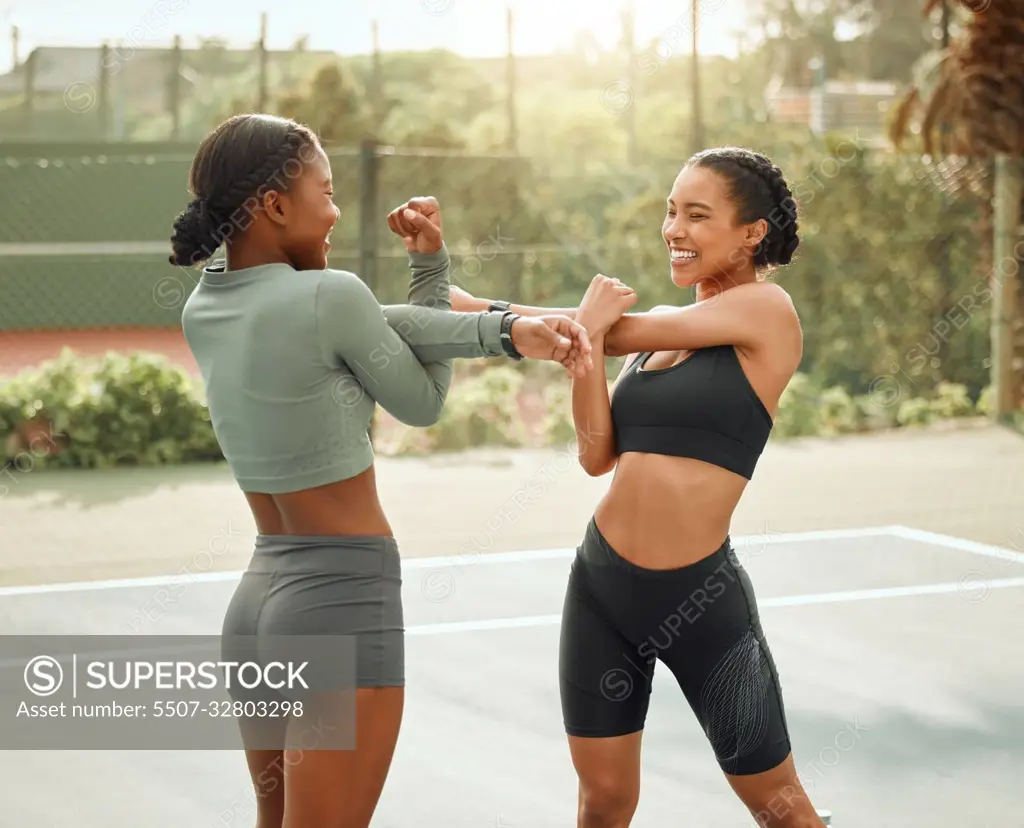 Stay warm. two attractive young female athletes warming up outside before beginning their workout.