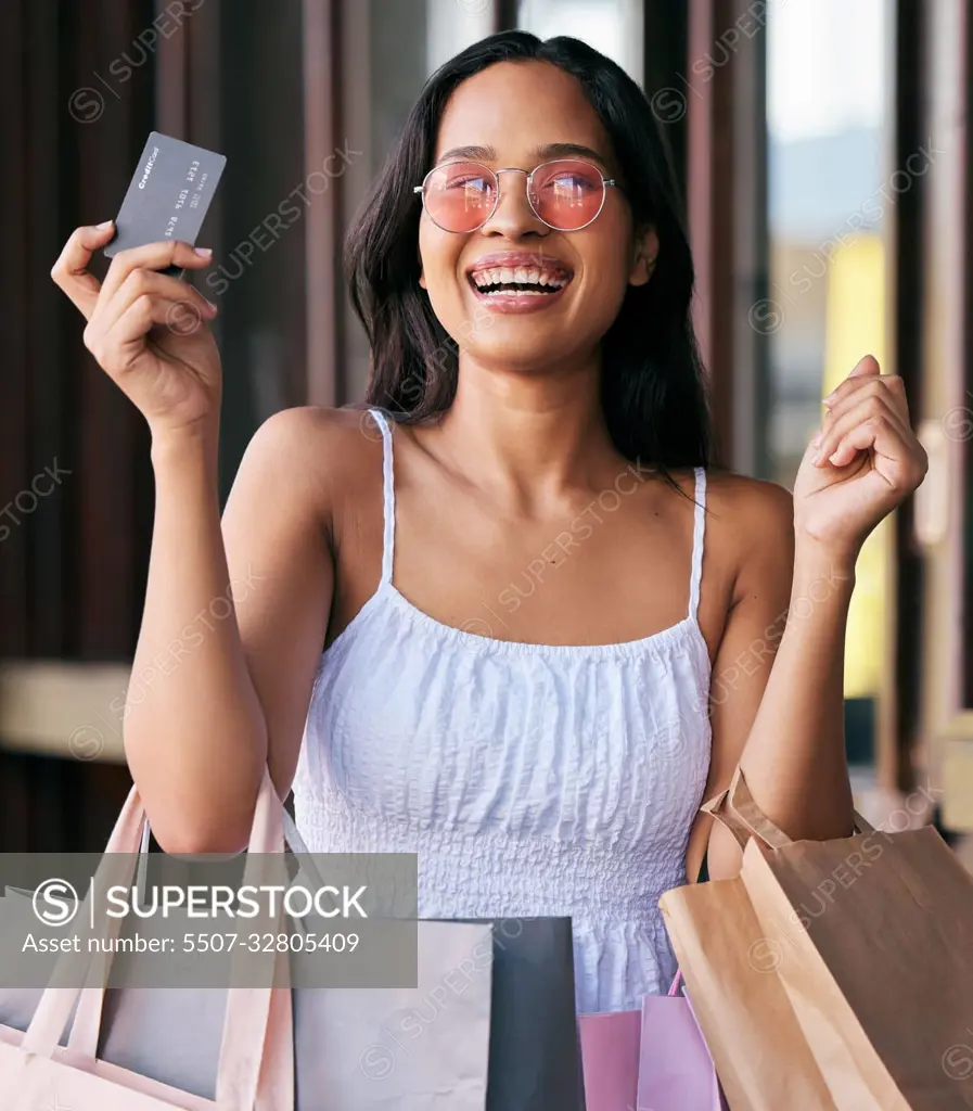 Woman, credit card and smile for shopping with bags in happy marketing, ecommerce or buying at the mall. Portrait of female shopper smiling with bank card for luxury, payment or purchase for clothing