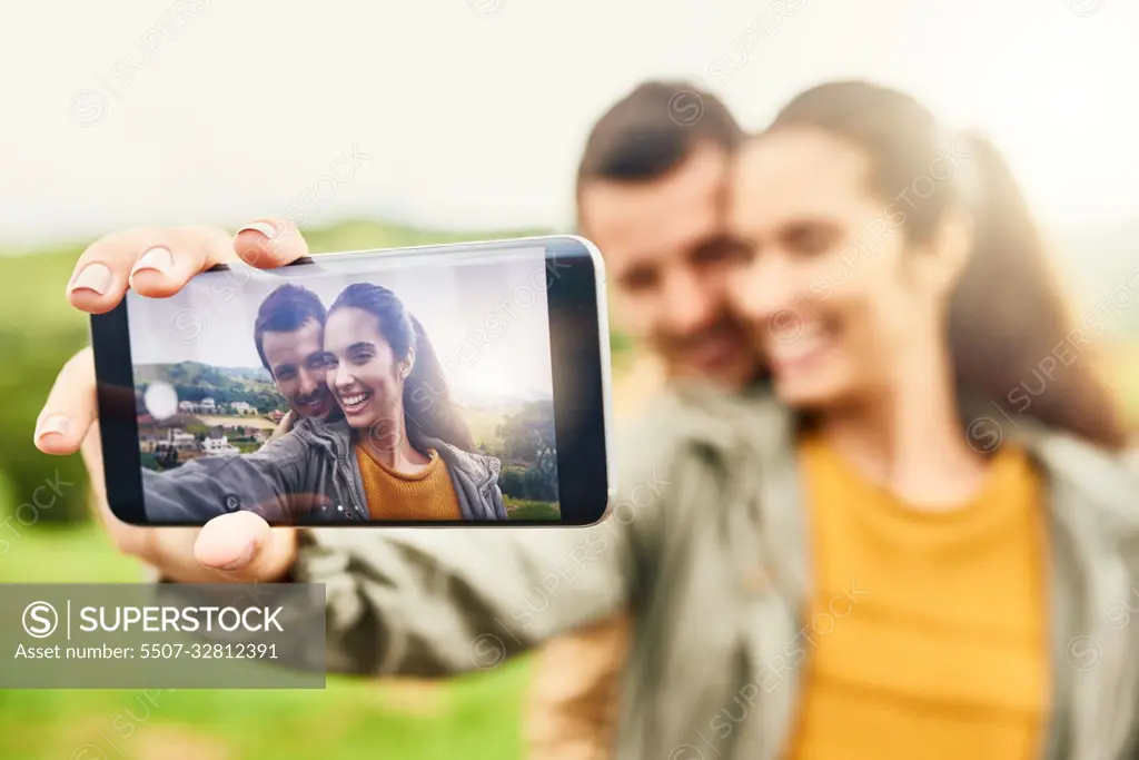 Their selfies are always on fleek. a loving couple taking a selfie outdoors.