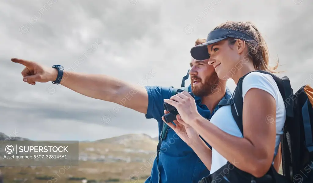 Pointing, travel and couple hiking on the mountains in a natural environment for an outdoors adventure in Canada. Freedom, lifestyle and healthy woman loves walking or trekking with partner in nature