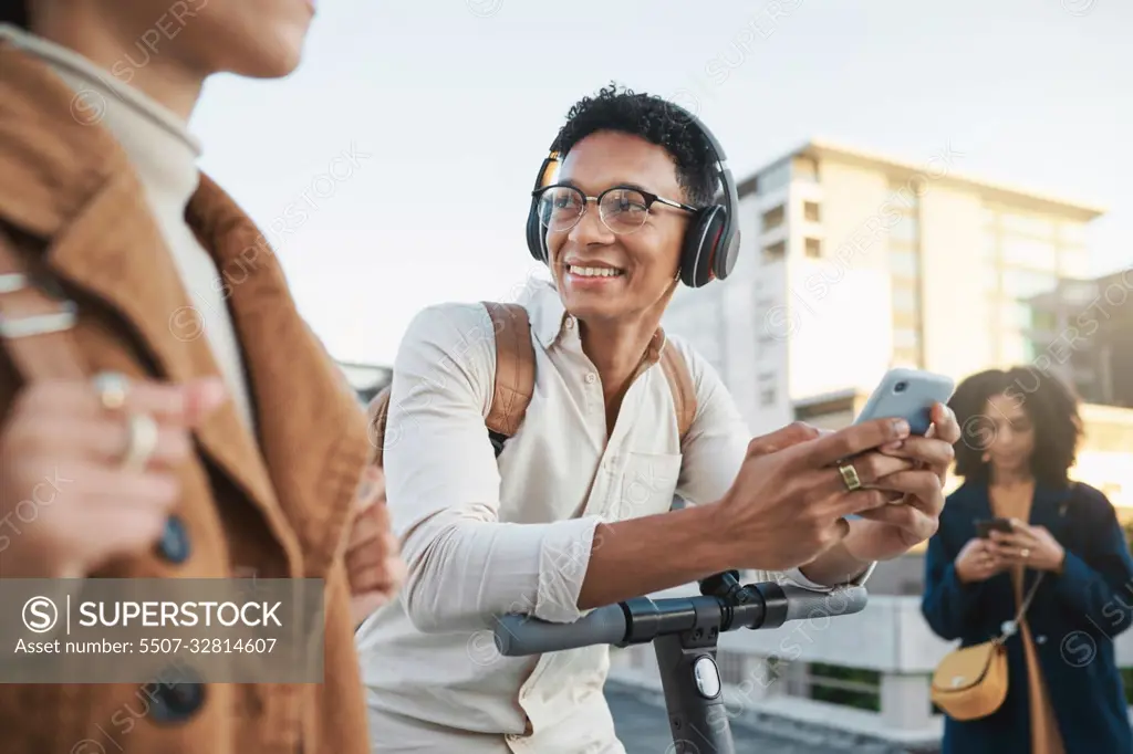 Phone, electric scooter and transport with a black man in the city on his commute into work. Technology, street and communication with a male employee typing a message while on a scooter for travel