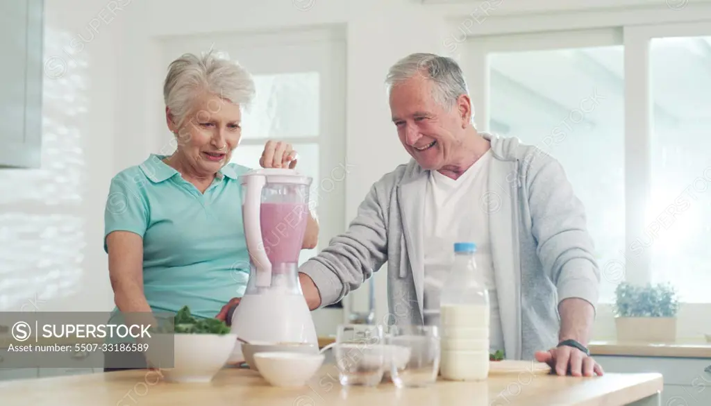 Lets start the day with a healthy smoothie. a senior couple making a healthy smoothie together at home.