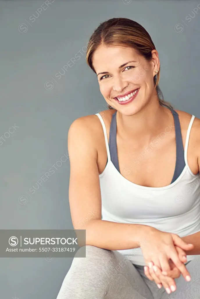 Living a happy and healthy lifestyle. a sporty young woman sitting on her fitness ball.