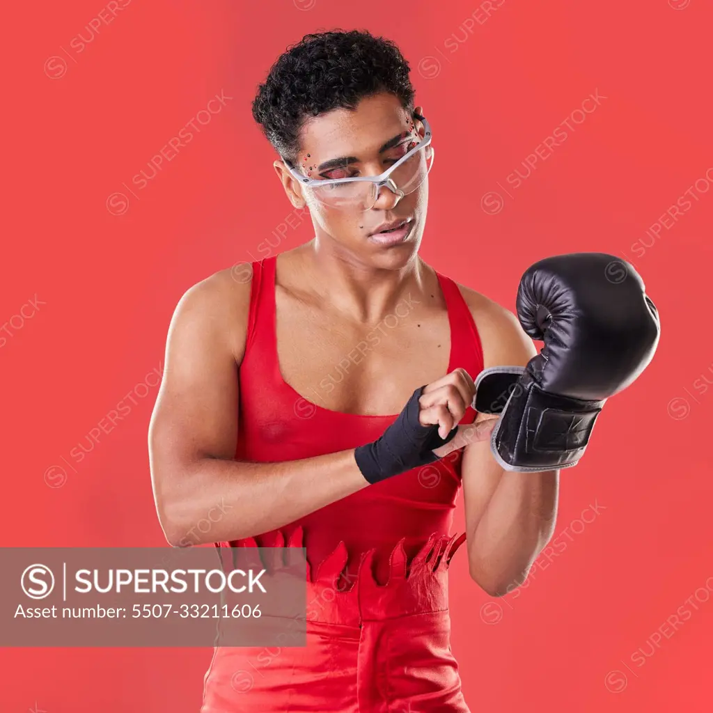 Gay man studio and boxing glove on hand with punk costume makeup