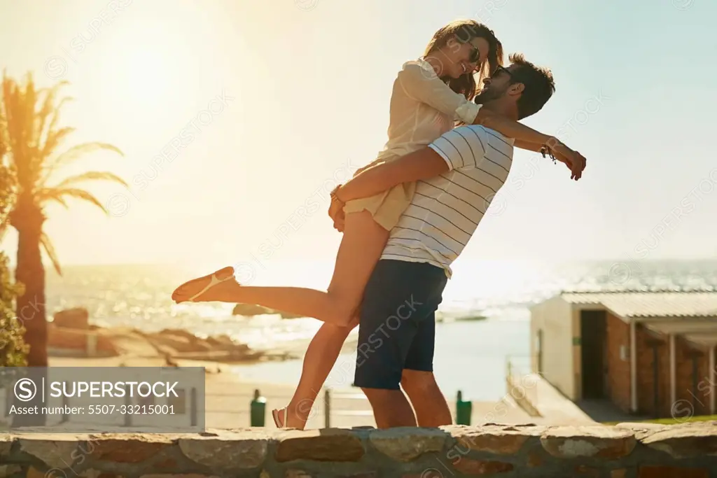 When summer love leads to true love. a happy young couple embracing on a summers day outdoors.