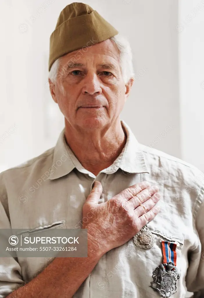 He has pledged his loyalty to the country. A senior war veteran looking at the camera wearing his uniform.