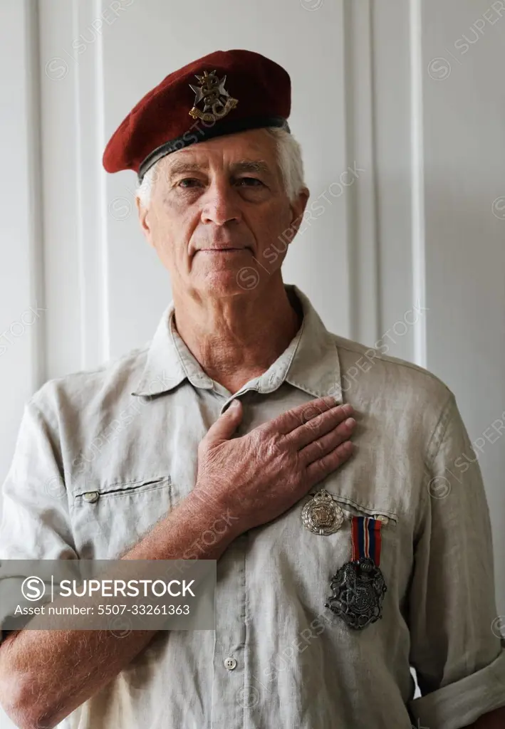 Im proud of the sacrifices Ive made. A senior war veteran looking at the camera wearing his uniform.