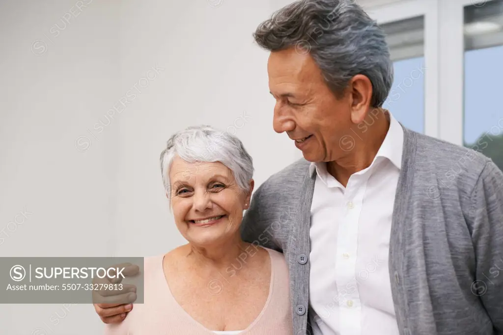 Loving retirement. an affectionate elderly couple at home.