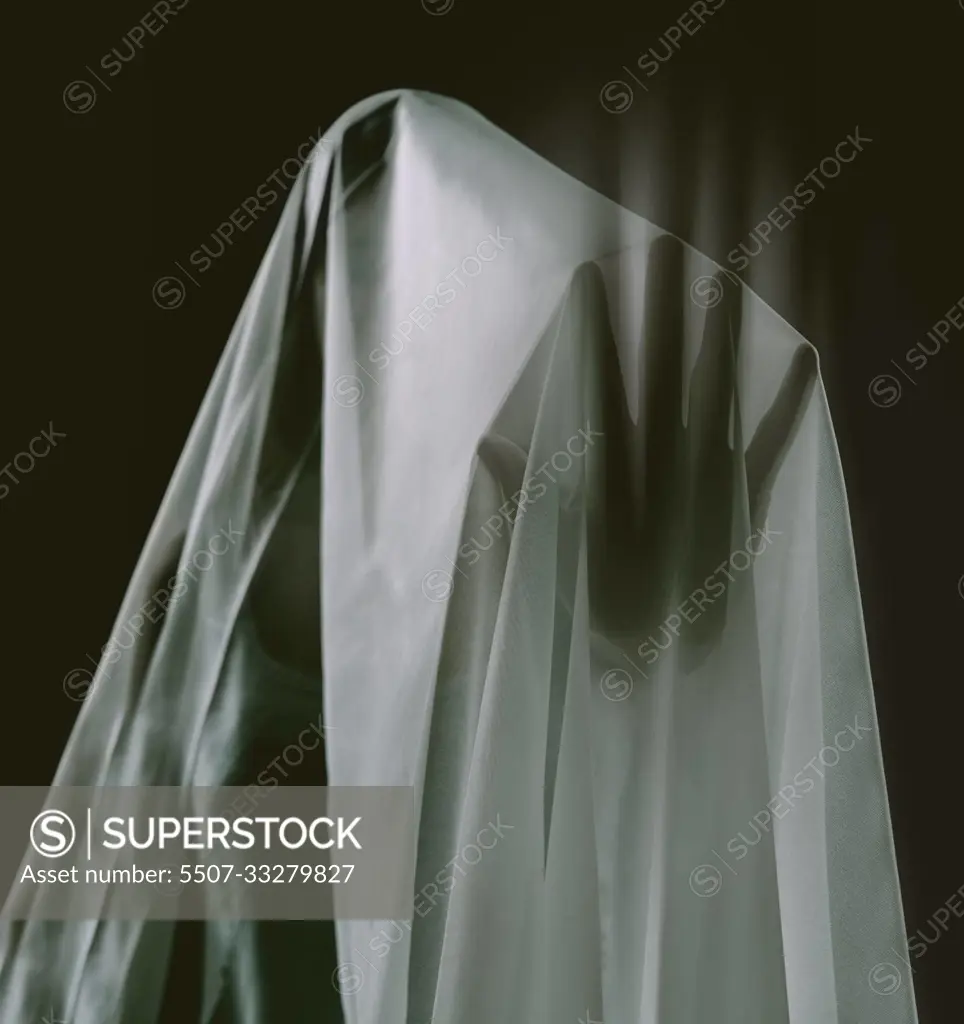 Touching the supernatural. A ghostly apparition of a woman isolated on a black background.