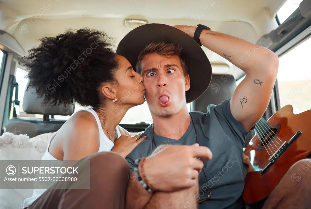 Couple, car and road trip with funny face, together and kiss on travel, vacation or holiday together on the road. Woman, man and comic time with love, happiness and joke in transport in Houston