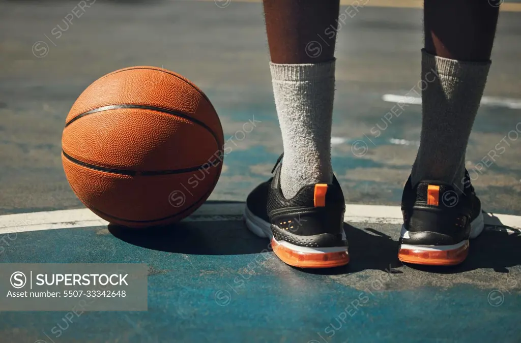 Basketball, basketball player and athlete legs close up on basketball court outdoors fitness training workout. Young African American man, sports exercise and healthy lifestyle motivation outside