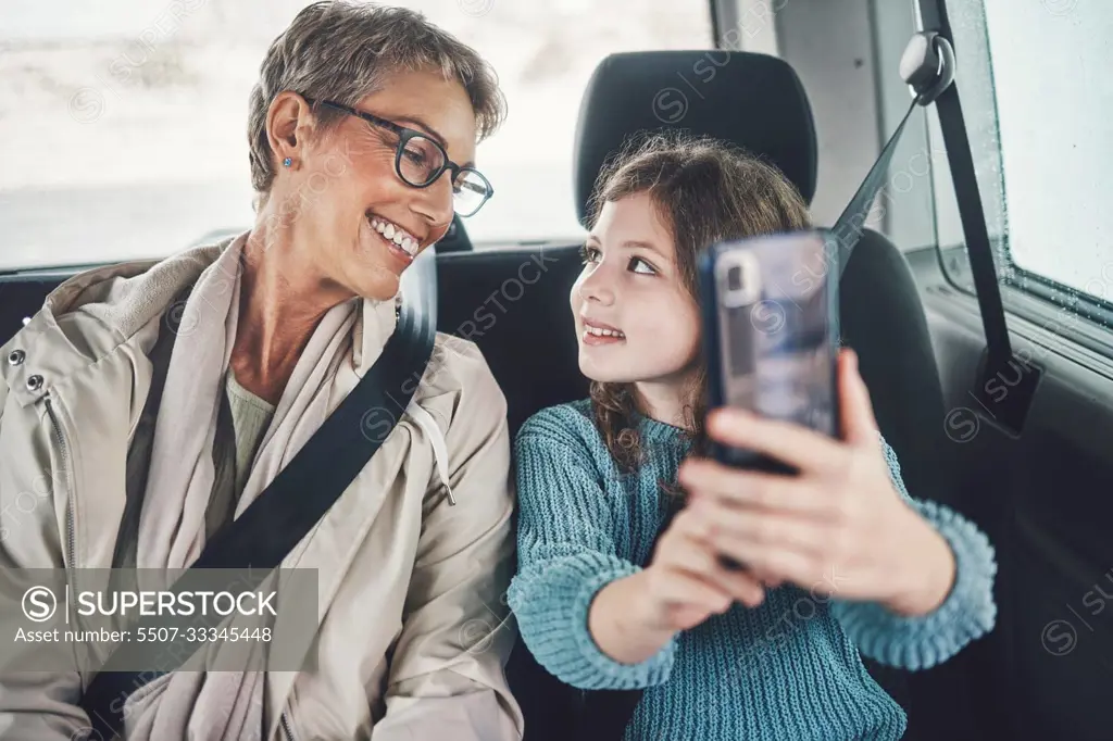 Travel, phone and selfie with girl and grandmother in car for road trip adventure on vacation for holiday, transportation and social media. Happy, smile and vacation with family for internet post