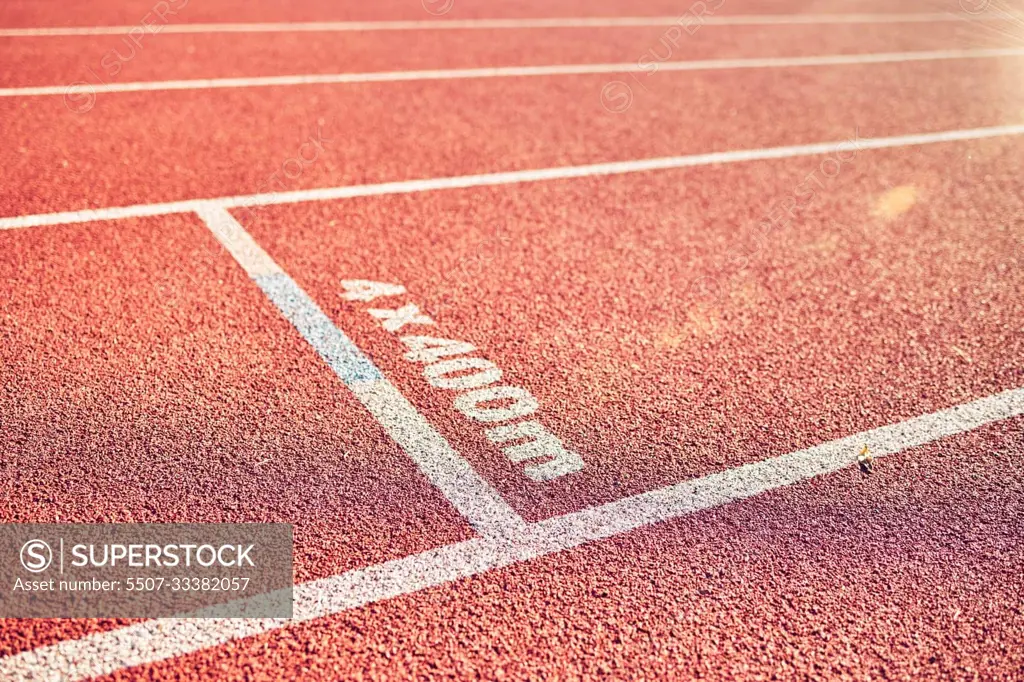 Sport, running track and stadium background for marathon, race and competition or fitness training for track and field athlete. Line, texture and path with nobody on rubber floor for fast run outdoor