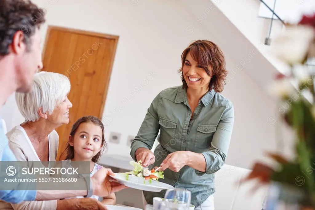 Bonding like a family should. a multi-generational family having a meal together.