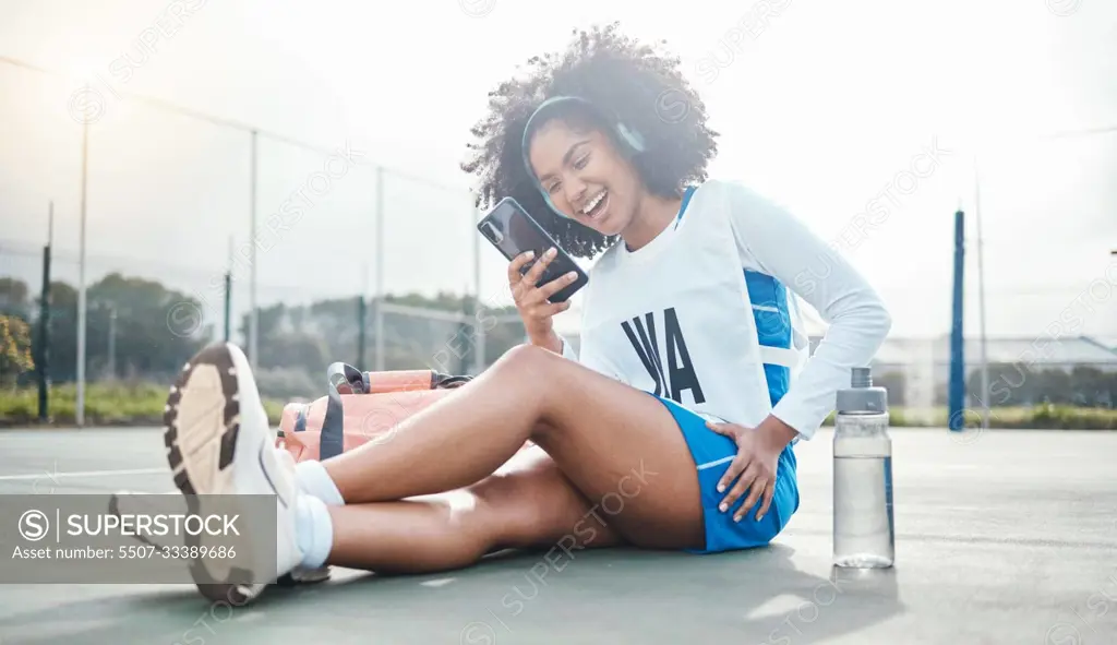 Netball sports, smartphone music and black woman listening to mp3 radio, audio podcast or media song. Laughing, online digital headphones and athlete streaming funny meme video after training workout