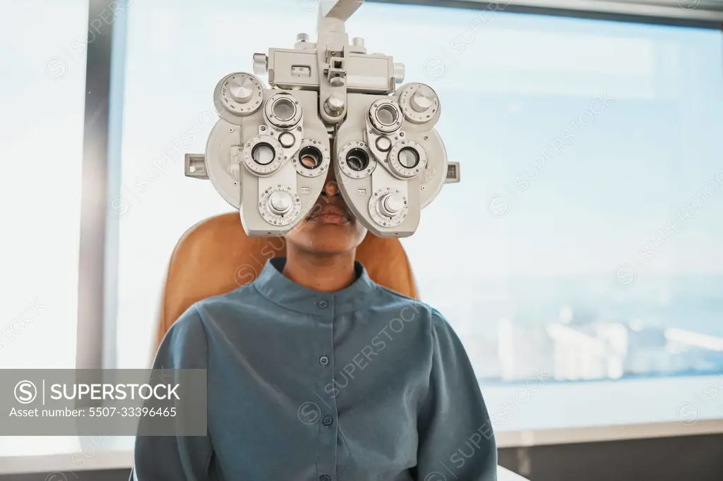 Optometry test, eye exam and black woman in clinic for testing, eyesight and optical assessment. Healthcare, optometrist consultation and patient with medical equipment, phoropter and lens for eyes