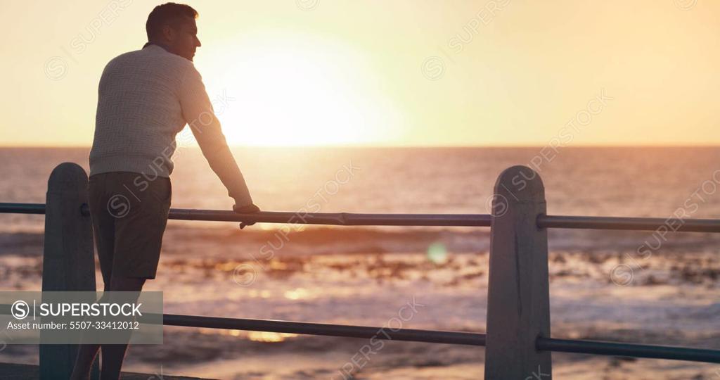 Back view, sunset and thinking man by beach on vacation or holiday