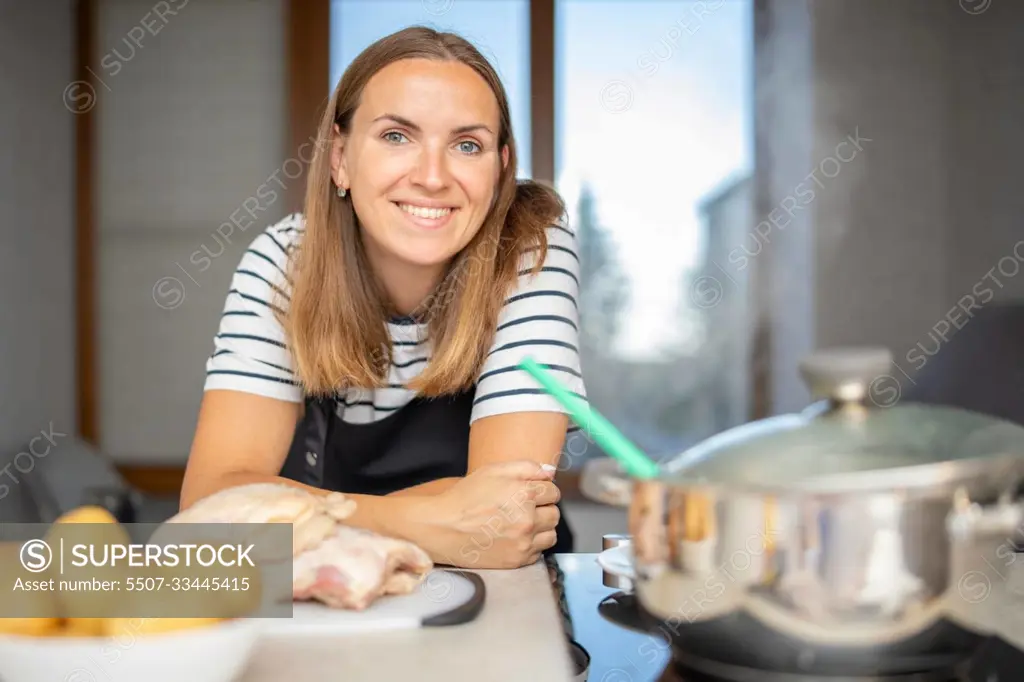 Young woman is cooking in the kitchen. Healthy eating. Healthy lifestyle.