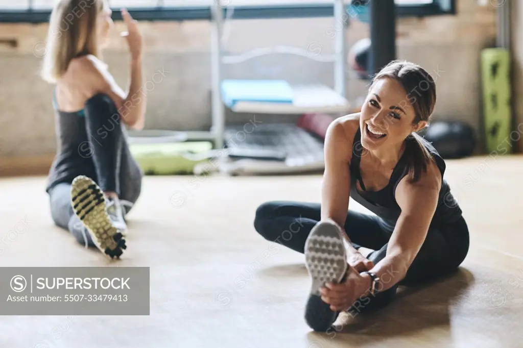 Portrait, stretching and women training, balance and workout for stress relief, wellness and healthy lifestyle. Face, female people and athletes on the floor, stretch legs and practice with progress