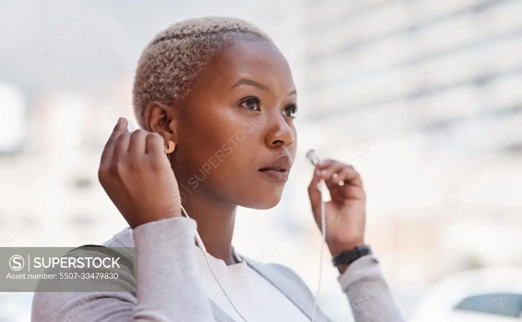 Music, thinking and vision with a business black woman in the city on her morning commute into work. Mindset, future and earphones with a young female employee streaming audio in an urban town