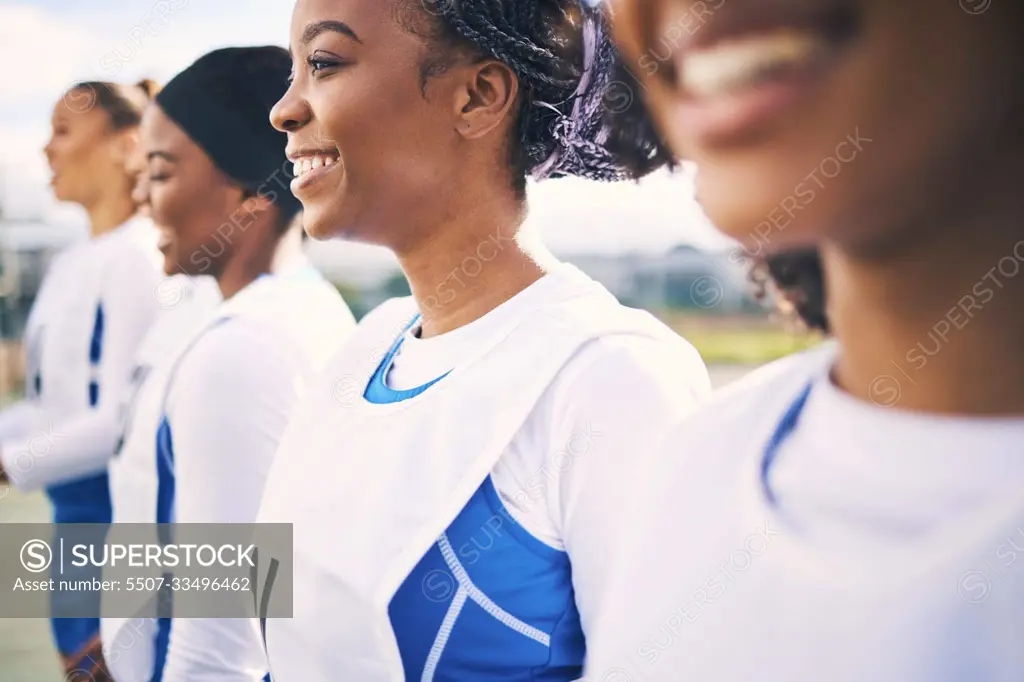 Sports, netball and team of women with smile ready for training, exercise and fitness workout on court. Diversity, teamwork and row of happy girl athletes with motivation for game, match and practice