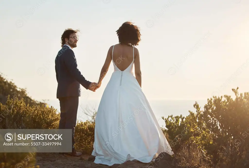 Love, wedding and holding hands with couple in nature park for celebration, romance and happiness. Sunset, support and summer with bride and groom in countryside for marriage, ceremony and bonding