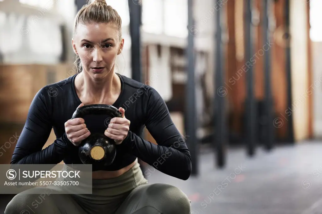 Kettlebell, fitness and portrait of woman in gym for weightlifting, bodybuilder training and strong muscles. Healthy body, weights and female person in sport center for wellness, exercise and workout