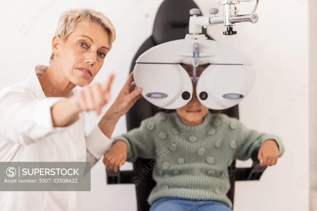 Vision, eye and test with a child at optometry exam with a specialist doctor in a clinic for glasses. Ophthalmology, optometry and medical expert eye test with little girl for eye health and eye care