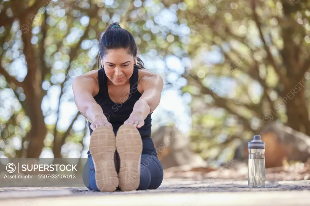 Woman, fitness and stretching leg, exercise and training outdoor for health, wellness and healthy lifestyle on floor. Stretch, workout and healthy person exercising legs on ground for body warm up