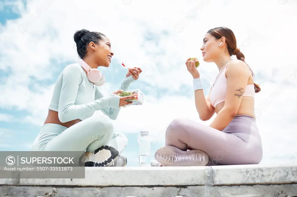 Salad, apple and fitness friends eating food outdoor for wellness, diet and vegan lifestyle with blue sky clouds mock up. Women or people with green fruits and vegetables lunch after an exercise