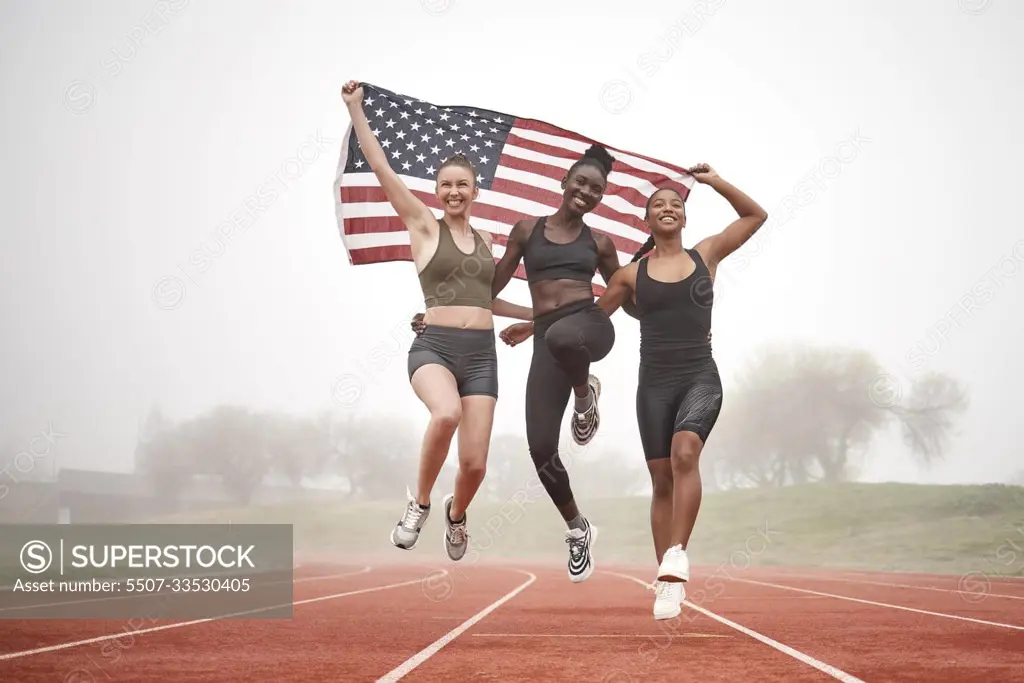 Remember to uplift your team members. Shot of a young sports team holding the american flag.