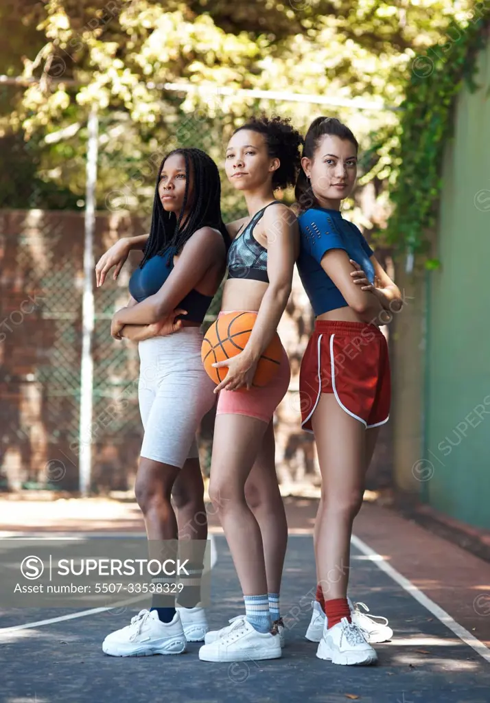 This team rocks. Full length portrait of three attractive young female athletes standing together on the basketball court.