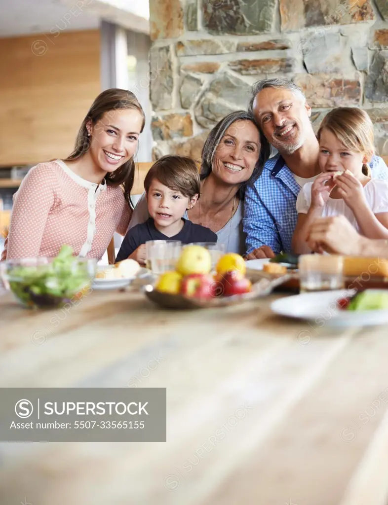 Treasured moments with the grandkids. A portrait of a happy multi-generational family sitting at a table and having lunch together.