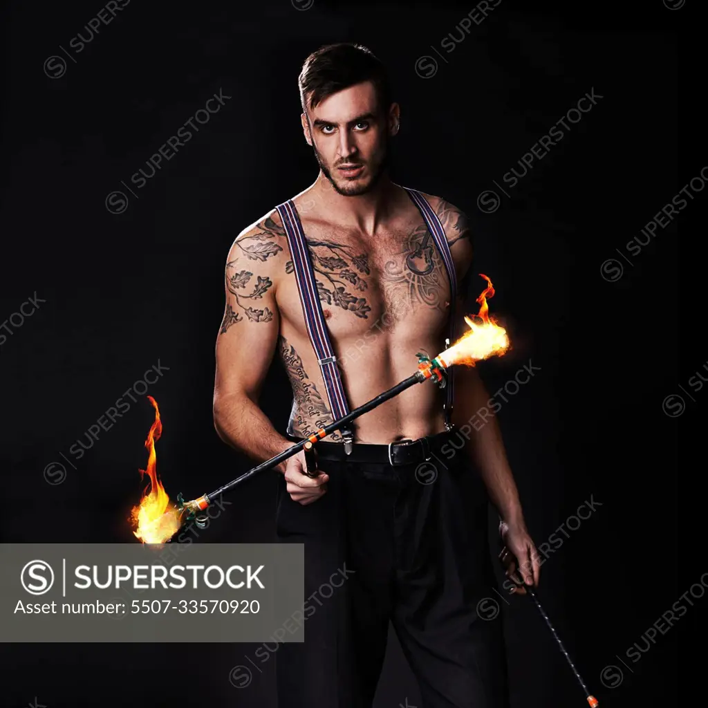 Its getting hot in here. Shot of a performer holding a flaming stick.