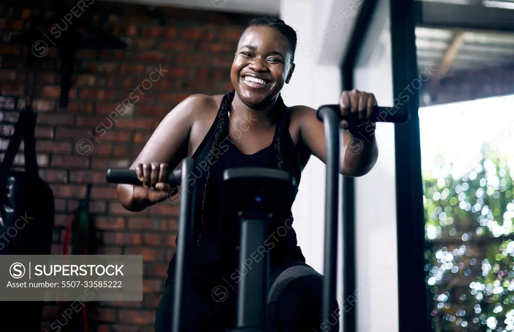 Upping my endurance. Cropped portrait of an attractive young female athlete working out on an elliptical machine in the gym.