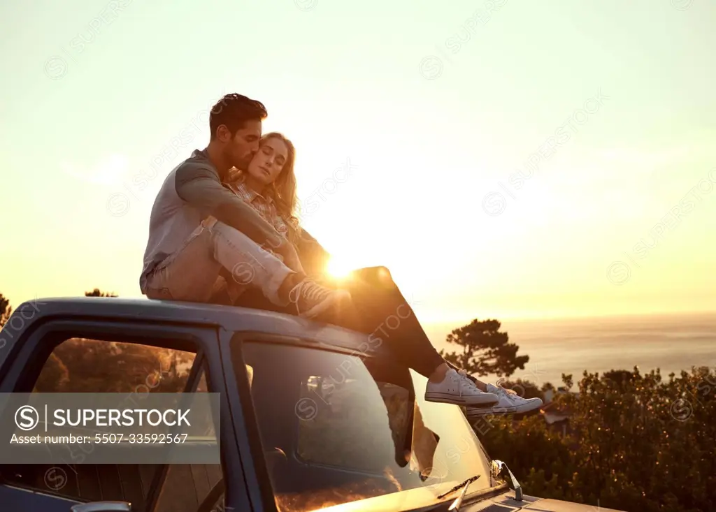 Romance on the road. Shot of an affectionate young couple enjoying a roadtrip together.