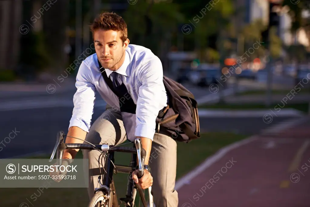 Really getting some exercise on the way to work. a businessman commuting to work with his bicycle.