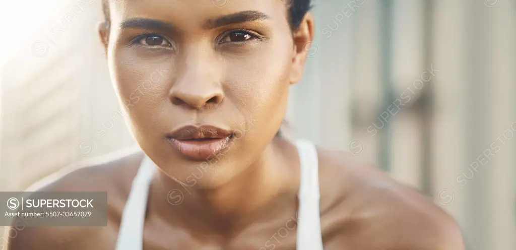 Face, portrait of a woman and fitness with a lens flare outdoors. Exercise or training, workout or motivation and closeup with African female athlete pose for health wellness or breathing