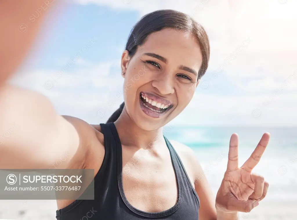 Fitness, selfie and woman at beach with peace hands for running, sports or exercise in nature. Portrait, happy and lady health and wellness influencer smile for social media, blog or profile picture