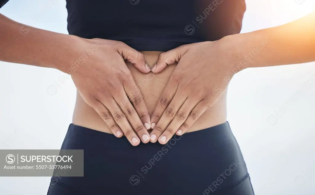 Woman, heart and hands on stomach for fitness, weightloss diet and gut wellness on flare of white background. Closeup, abdomen and finger shape of love, emoji or sports exercise for healthy digestion