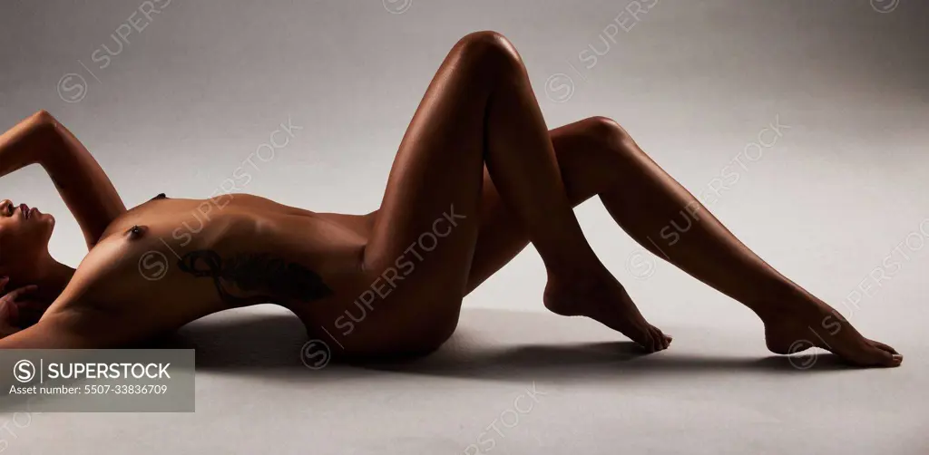 Hot Boobs Models Nude - Nude, boobs and sexy naked woman lying on the floor isolated in studio  black background. Skin, model and sensual female posing in hot, erotic and  beautiful artistic body as a young adult -