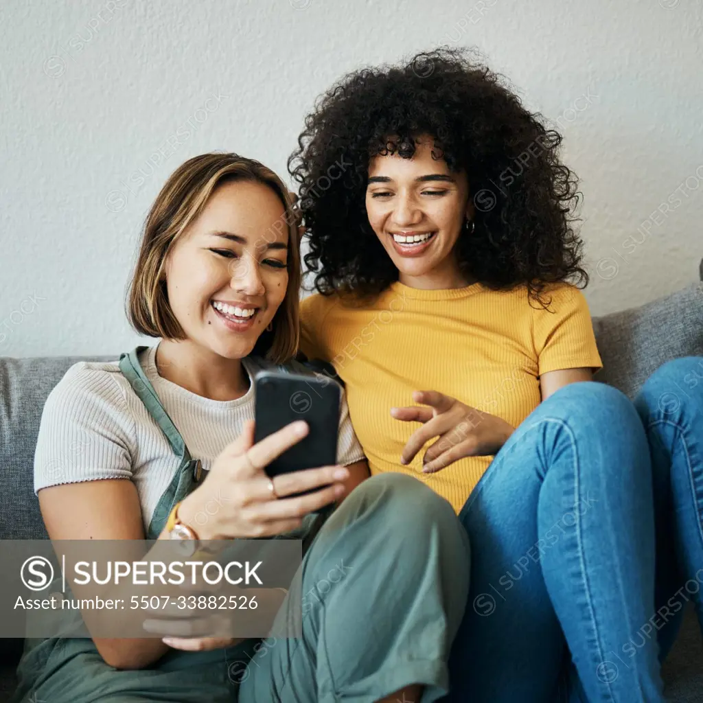 Friends, relax on sofa with smartphone and chat online with communication, funny meme and reading text message. Women with technology, mobile app and typing on social media with connectivity at home