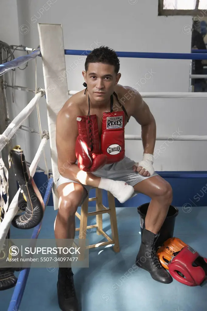 Man sitting in corner of boxing ring