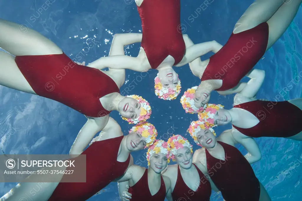 Synchronised swimmers in 1950s swimming caps