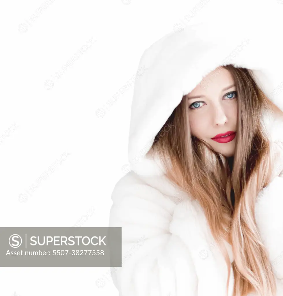Portrait of young woman in warm clothes wearing winter parka