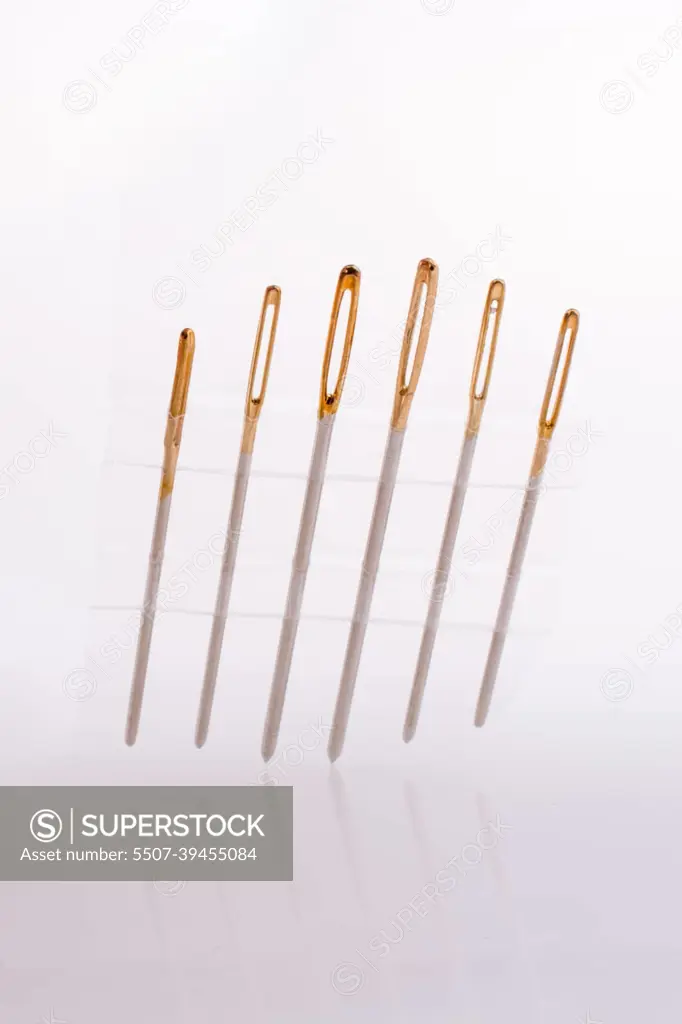 Six different sewing needles isolated on a white background